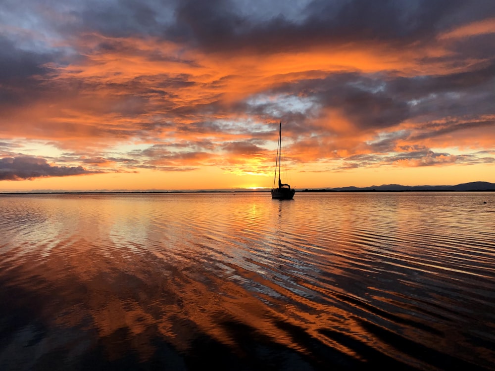 a sailboat floating on top of a large body of water