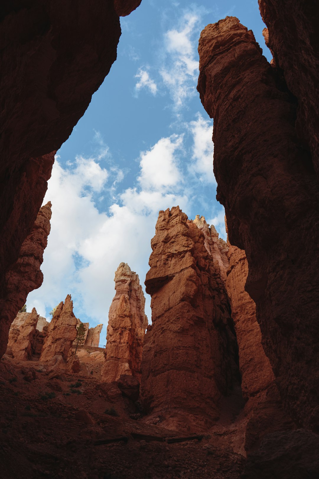 a view of the sky through some rocks