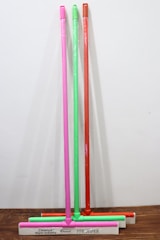 Set of different sized squeegees arranged neatly on a wooden table.