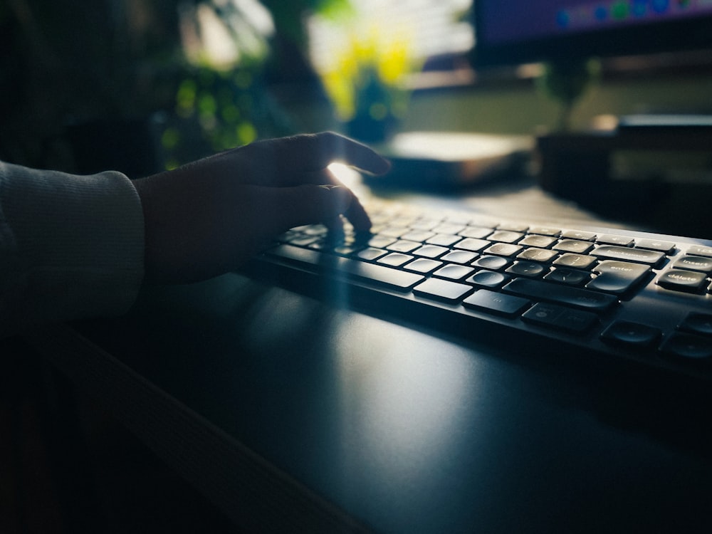 a person is typing on a computer keyboard