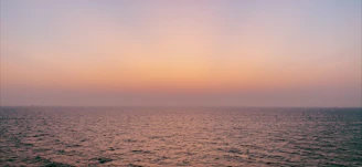 A serene ocean horizon blending shades of blue and white under a soft morning sky.