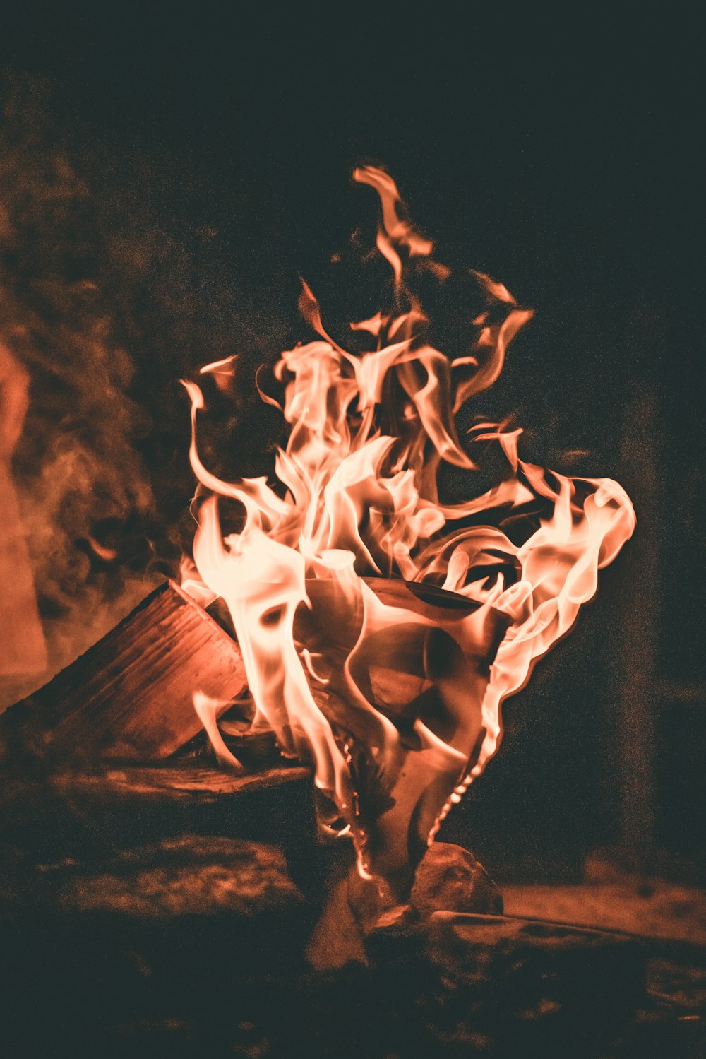 a fire burning in a fireplace with a black background