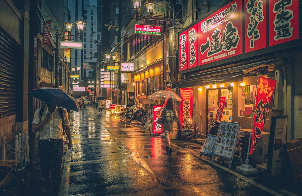 a woman walking down a street holding an umbrella