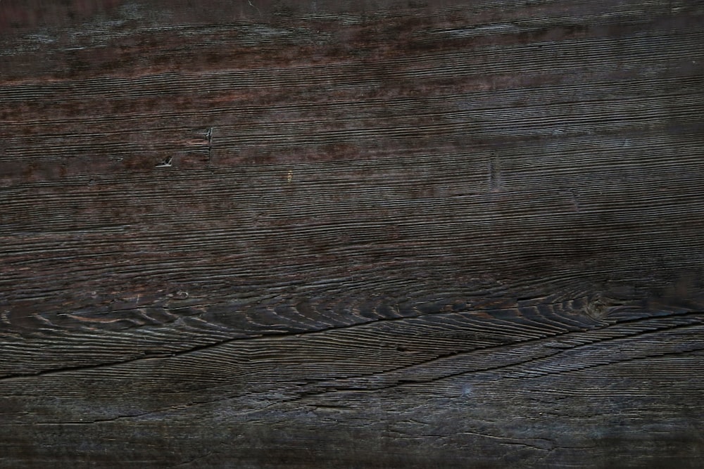 an orange slice of pizza sitting on top of a wooden table