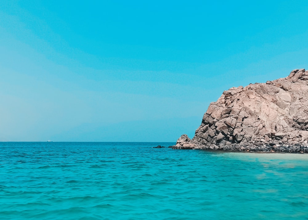 a rock outcropping in the middle of the ocean