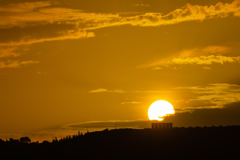 the sun is setting over the horizon of a city