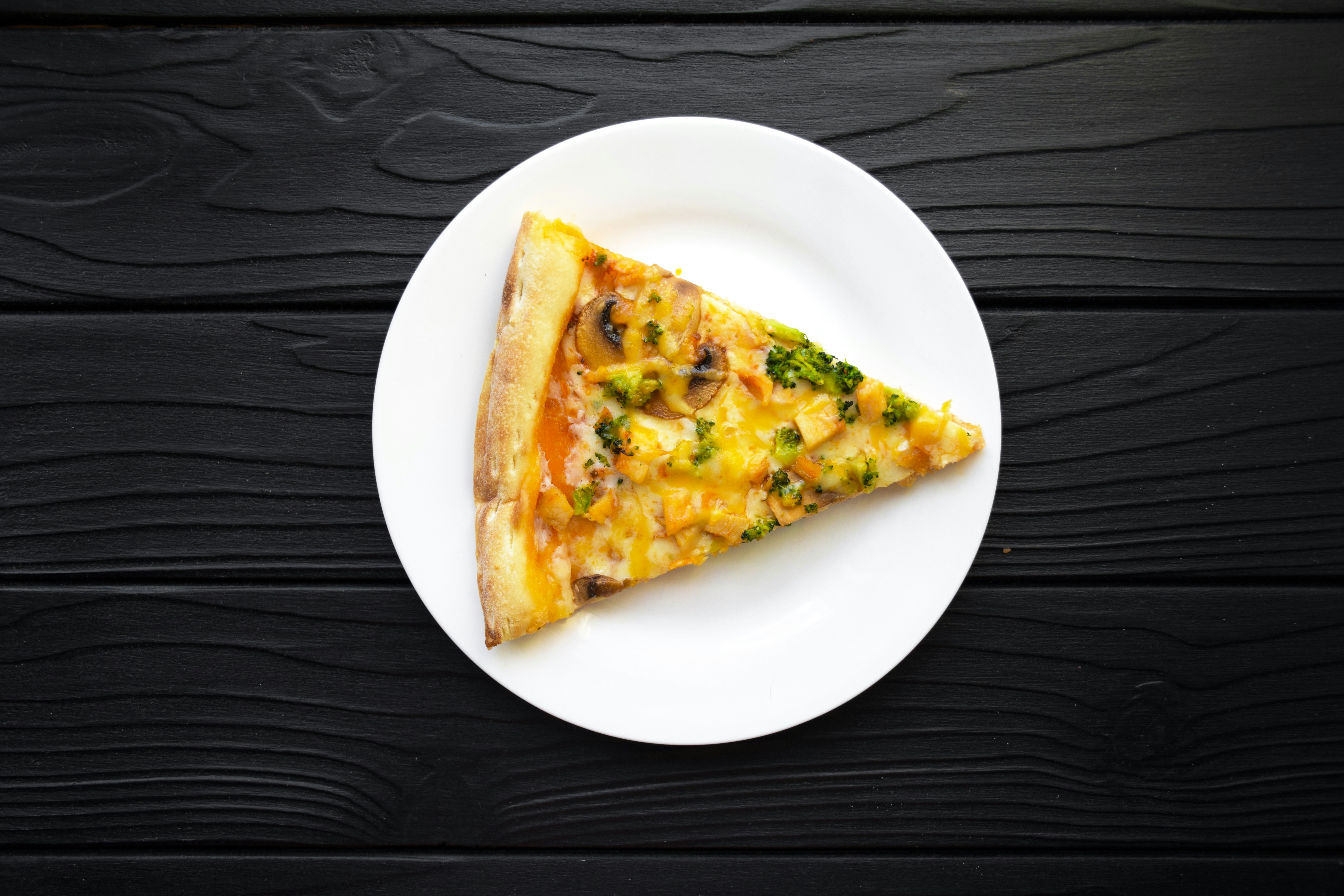 a slice of pizza on a white plate