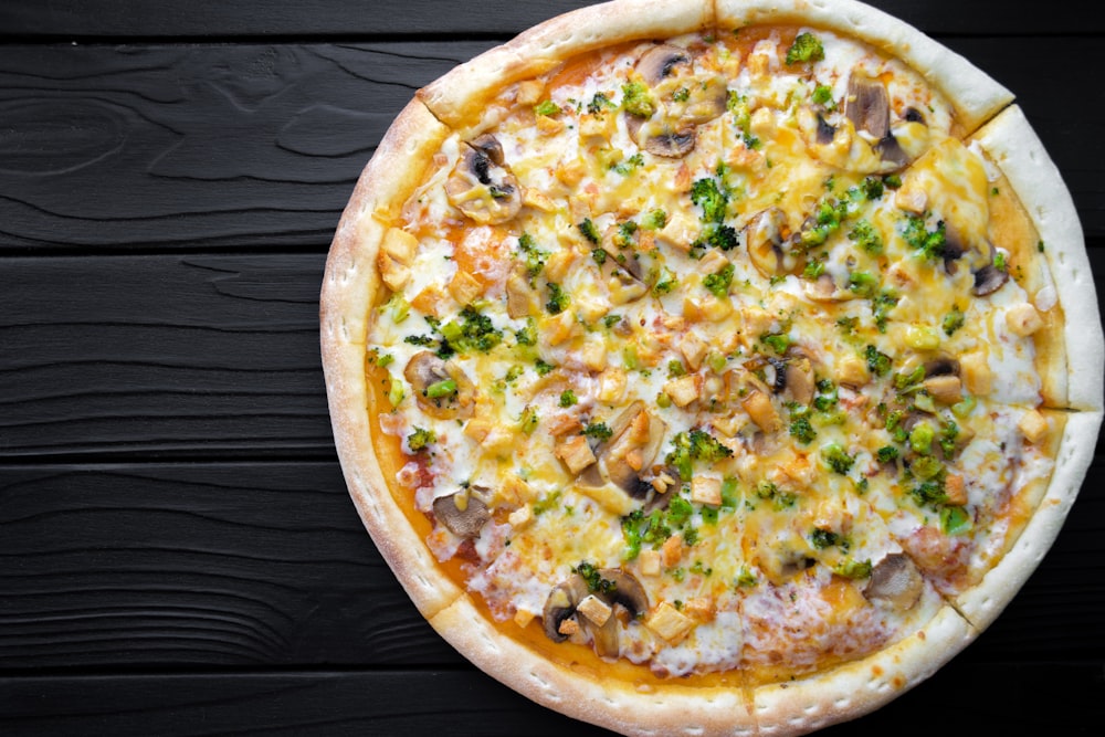 a pizza sitting on top of a wooden table