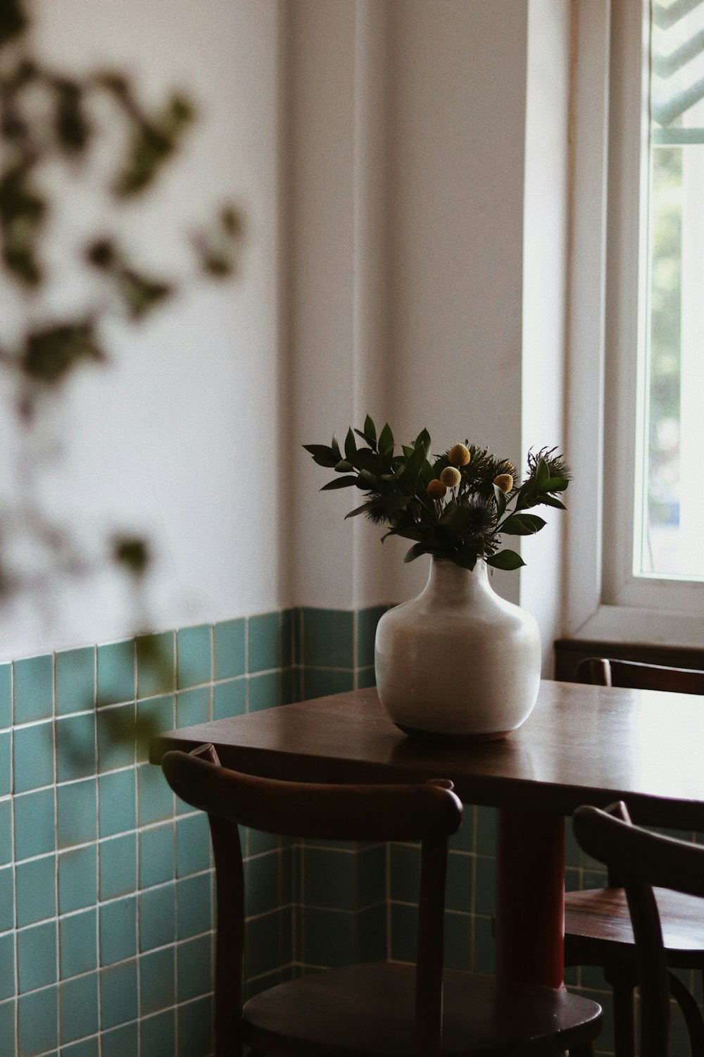 a table with a vase of flowers on top of it