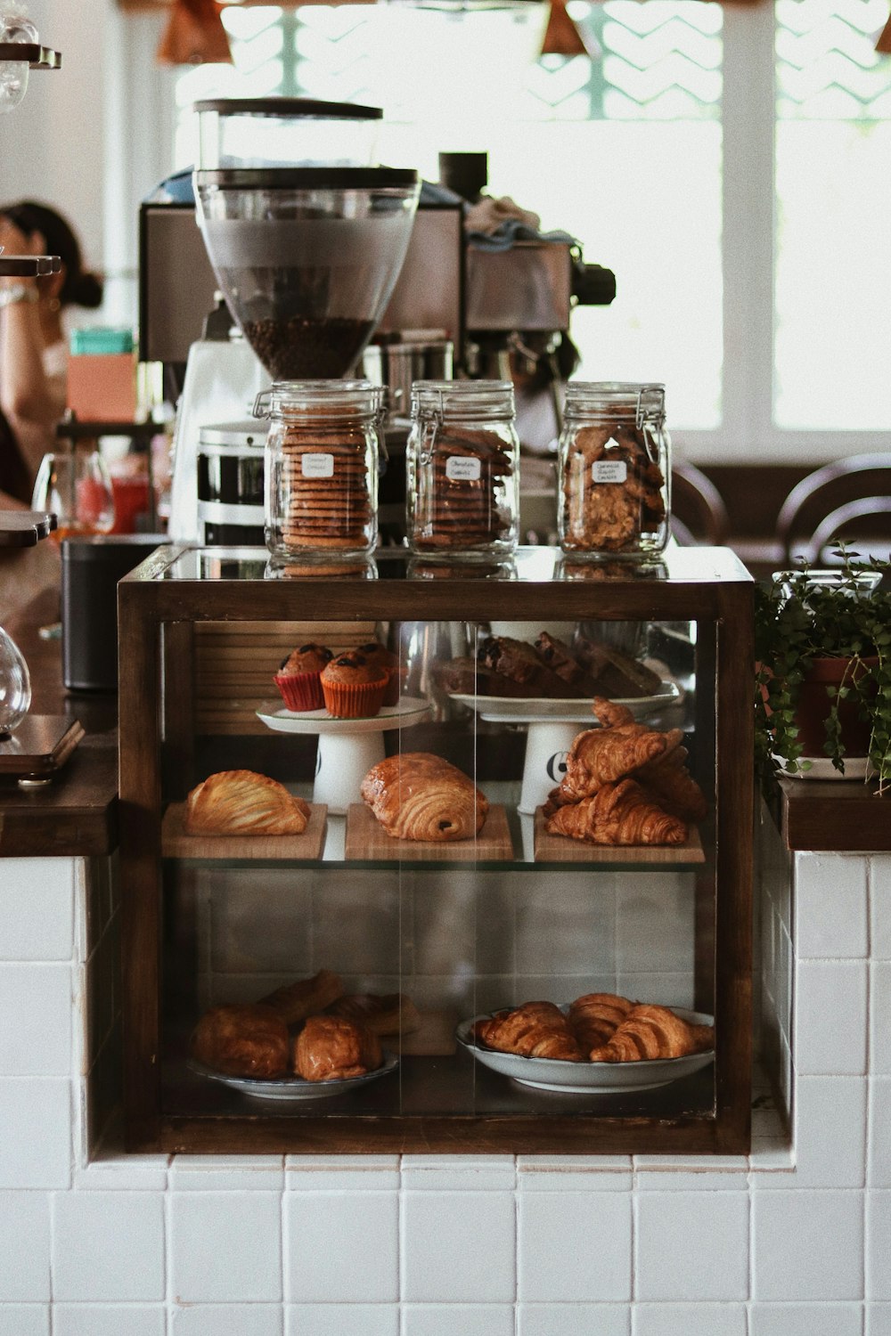 a bakery counter with pastries and coffee machines