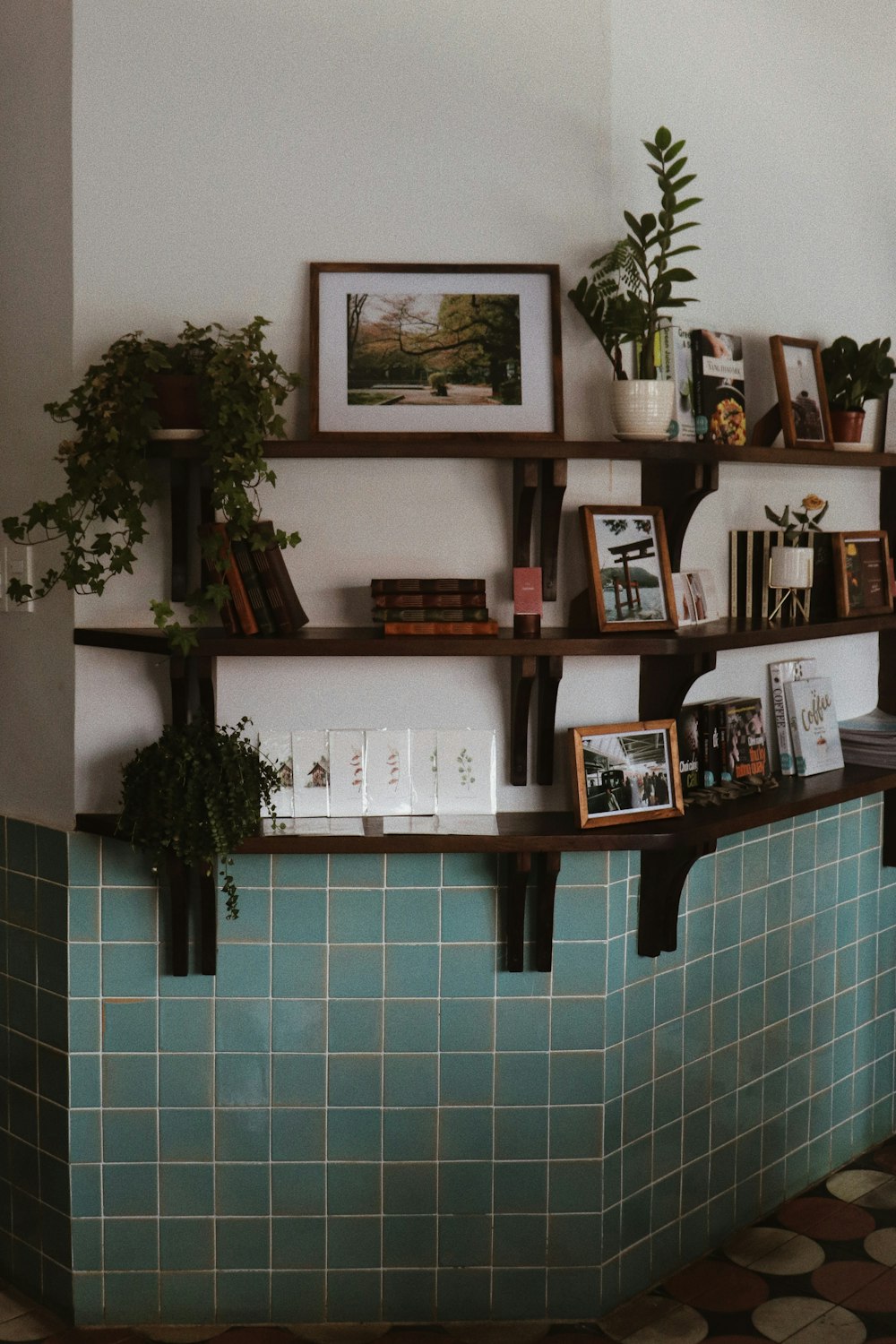 a room with a tiled floor and a wall with bookshelves