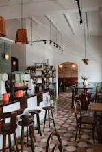 a restaurant filled with lots of tables and chairs