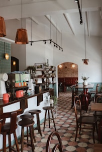 A cozy café interior showcasing a row of wooden bar stools lined up at a counter.
