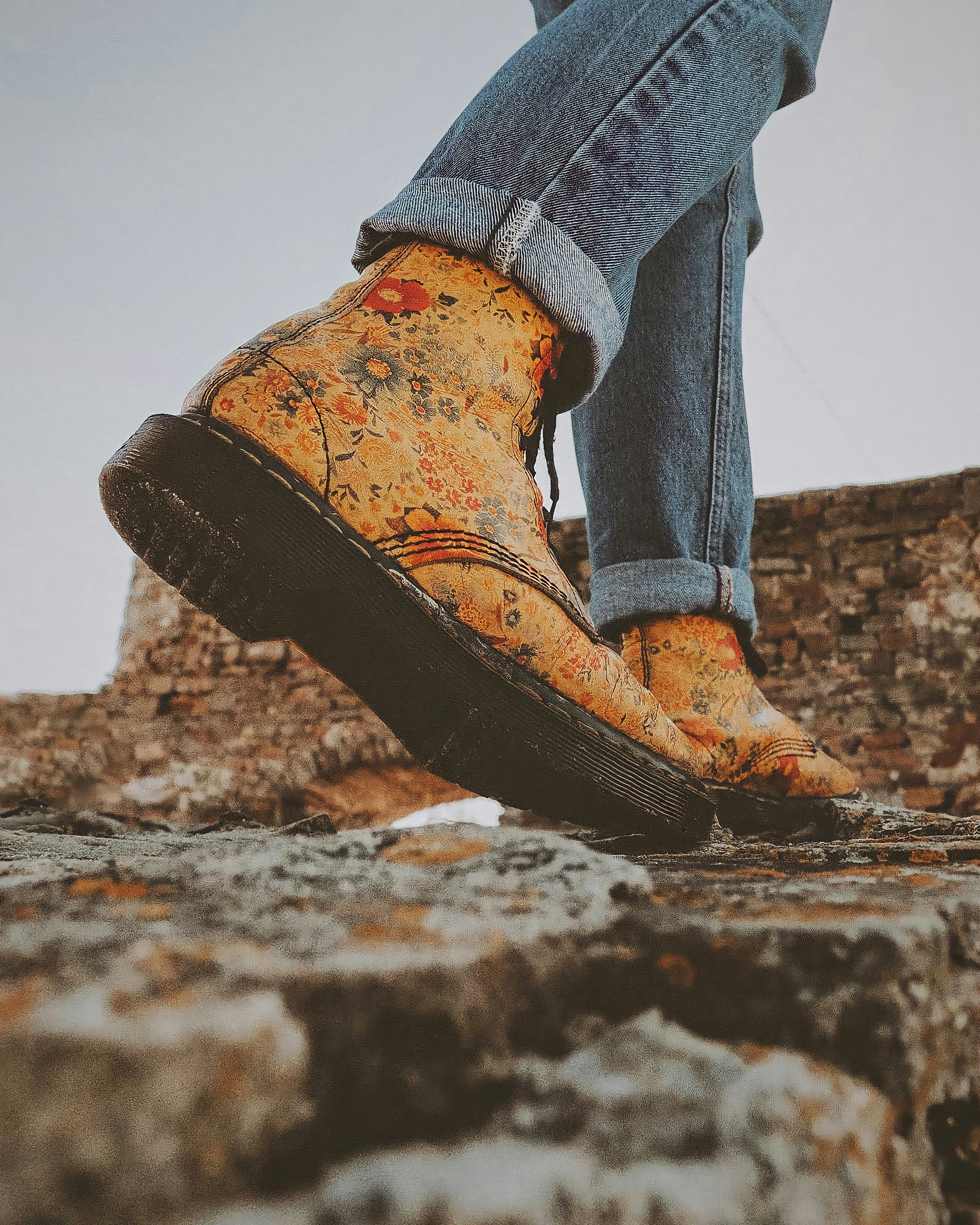 a person standing on top of a stone wall