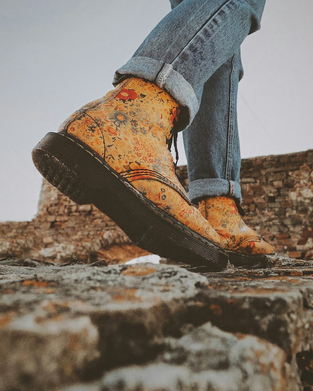 a person standing on top of a stone wall