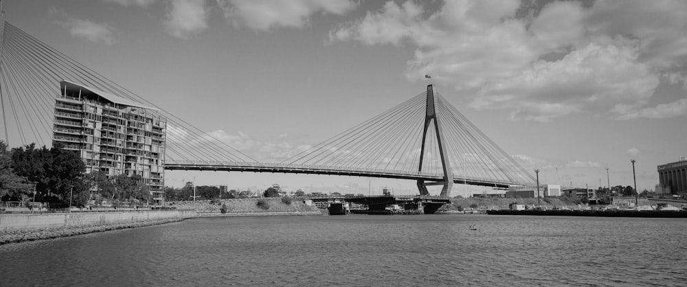 a black and white photo of a bridge over a body of water