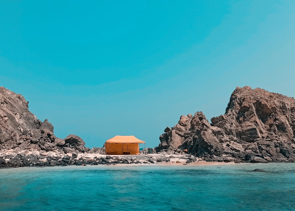 a small hut on the shore of a beach