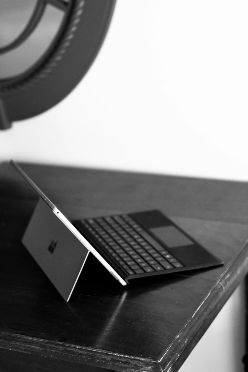 a laptop computer sitting on top of a wooden desk