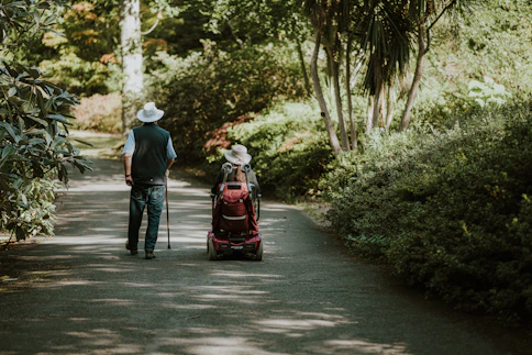 a man and a woman walking down a dirt road