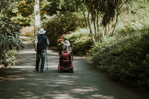 a man and a woman walking down a dirt road