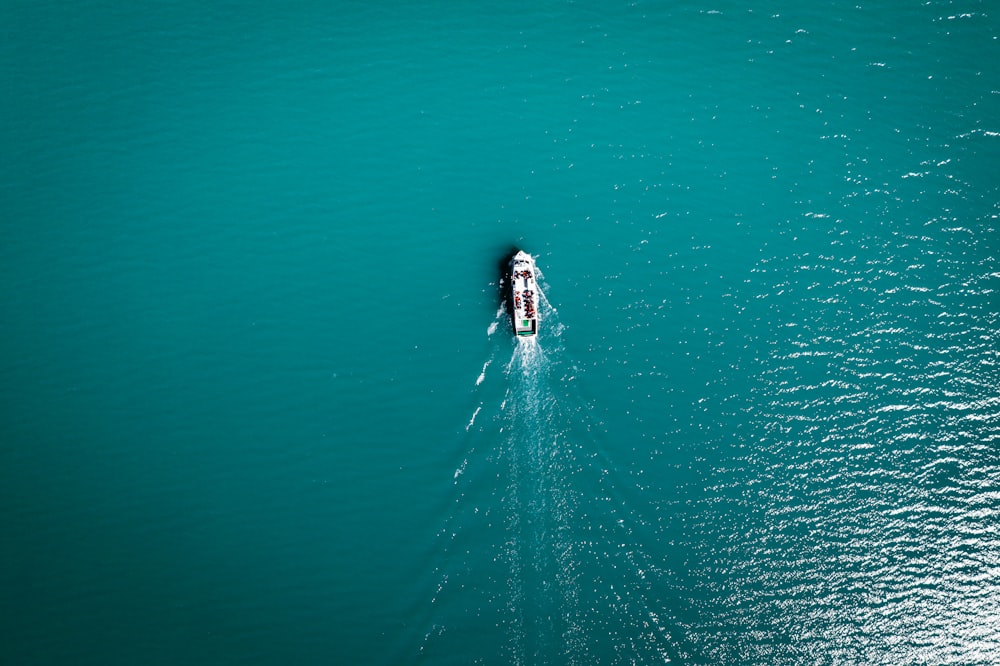 a small boat in the middle of a large body of water