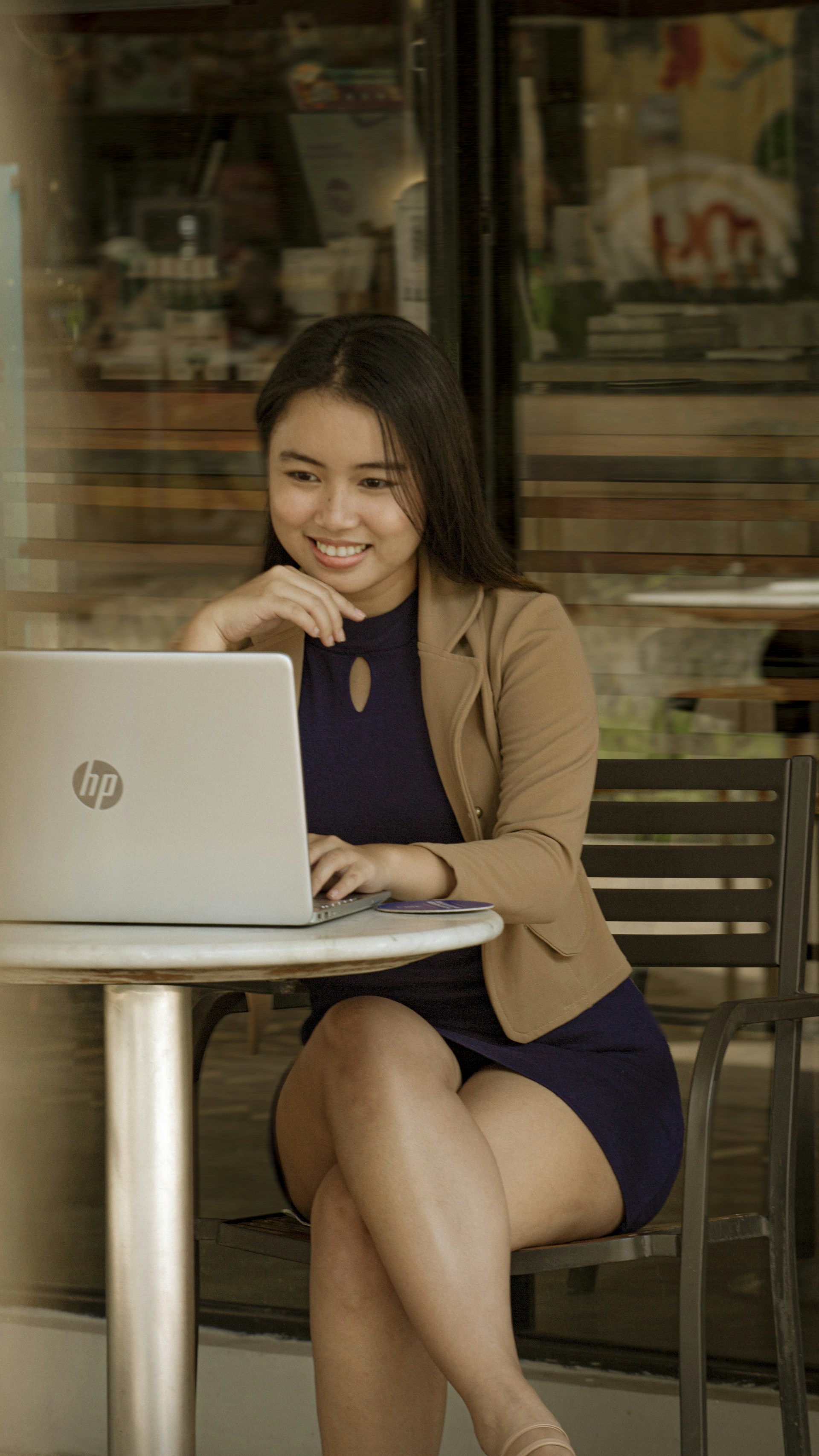 a woman sitting at a table with a laptop