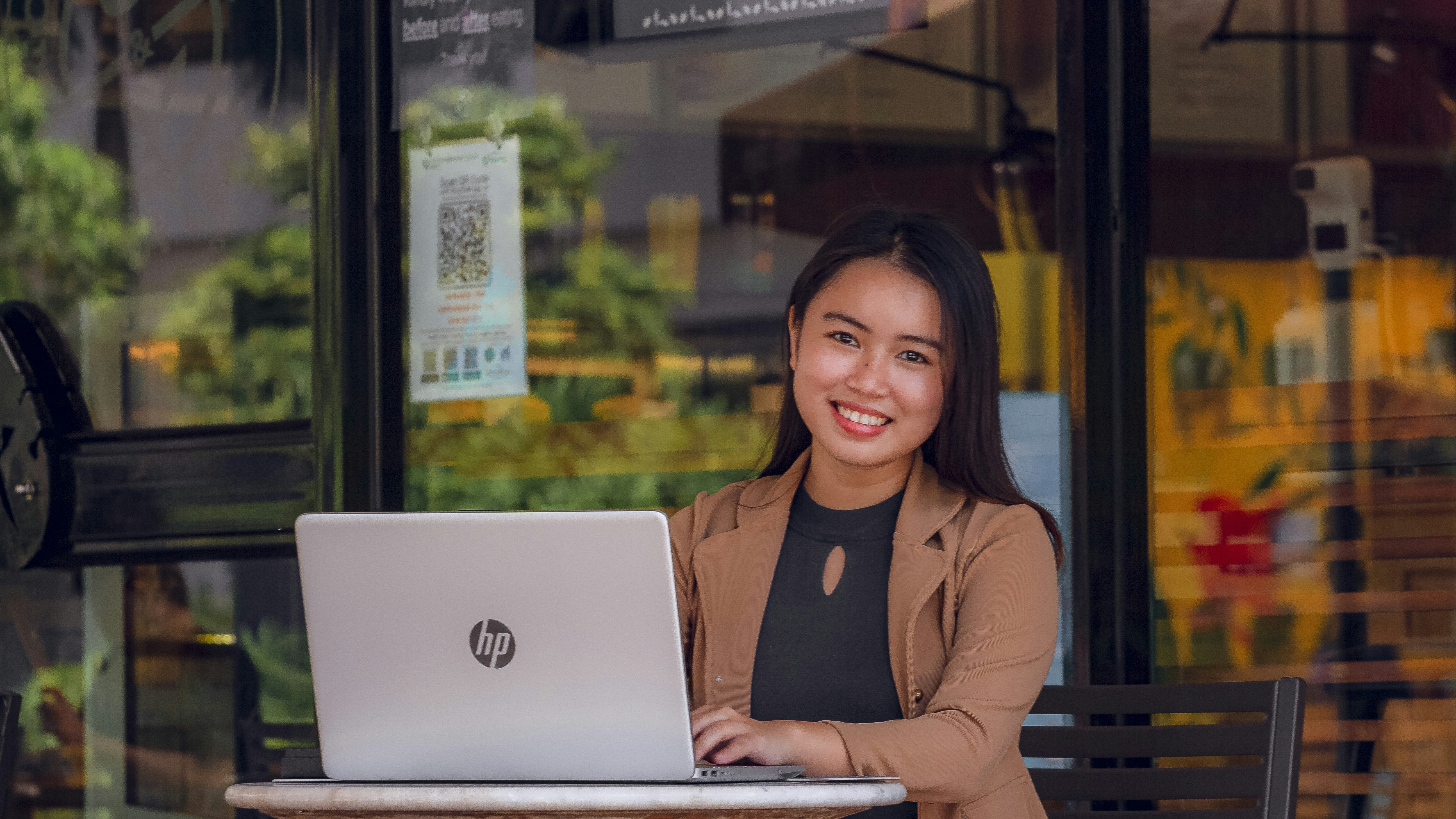 Student smiling at laptop screen with business school acceptance email - gmat personal tutor