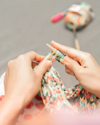 a woman is knitting a piece of fabric-Kanha Universal Export