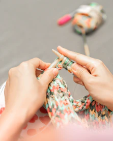 a woman is knitting a piece of fabric-Kanha Universal Export