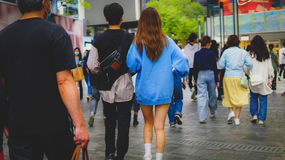 a group of people walking down a street