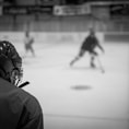 a group of people playing a game of ice hockey