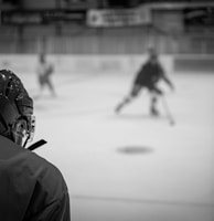 a group of people playing a game of ice hockey