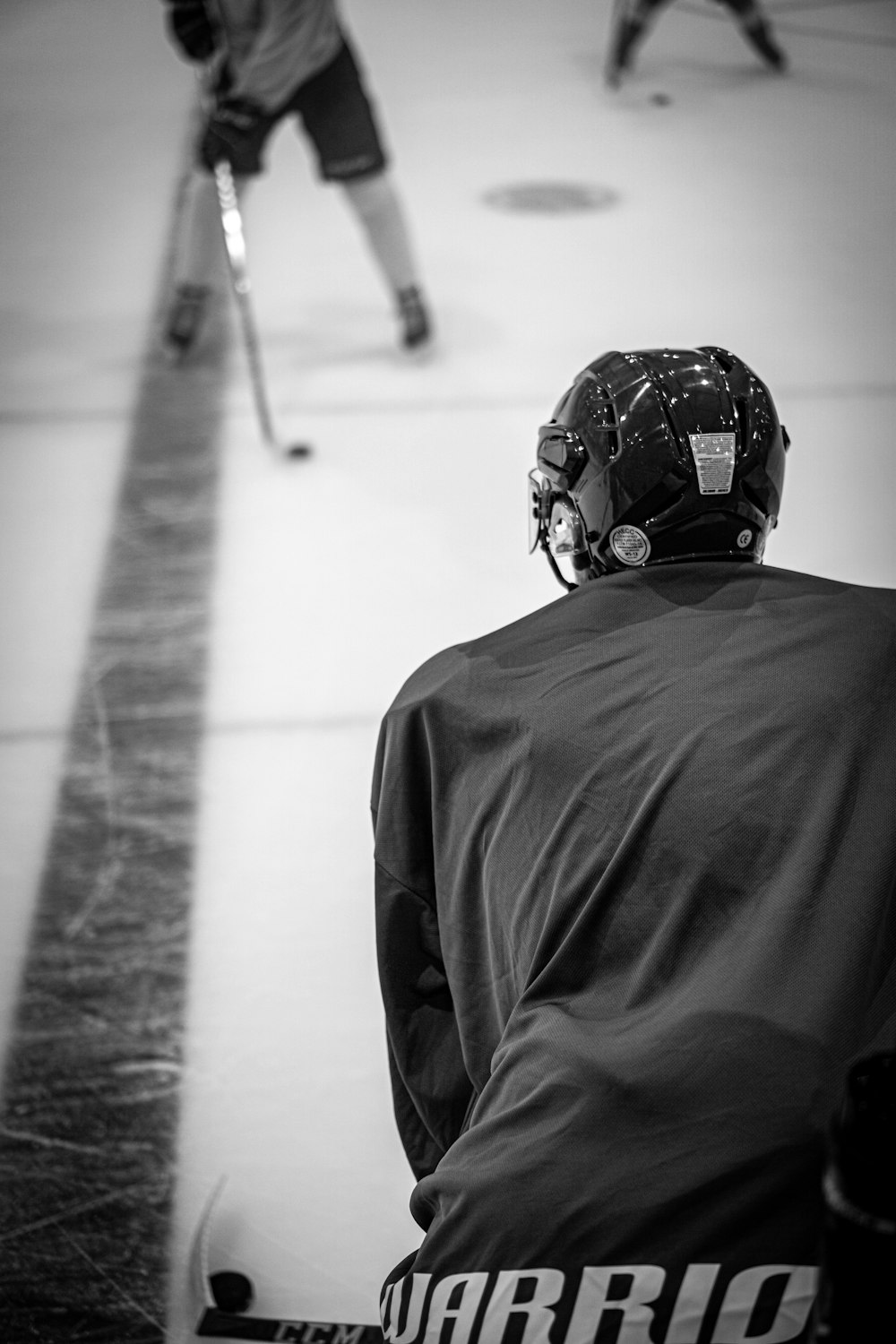 a hockey player is sitting on the ice