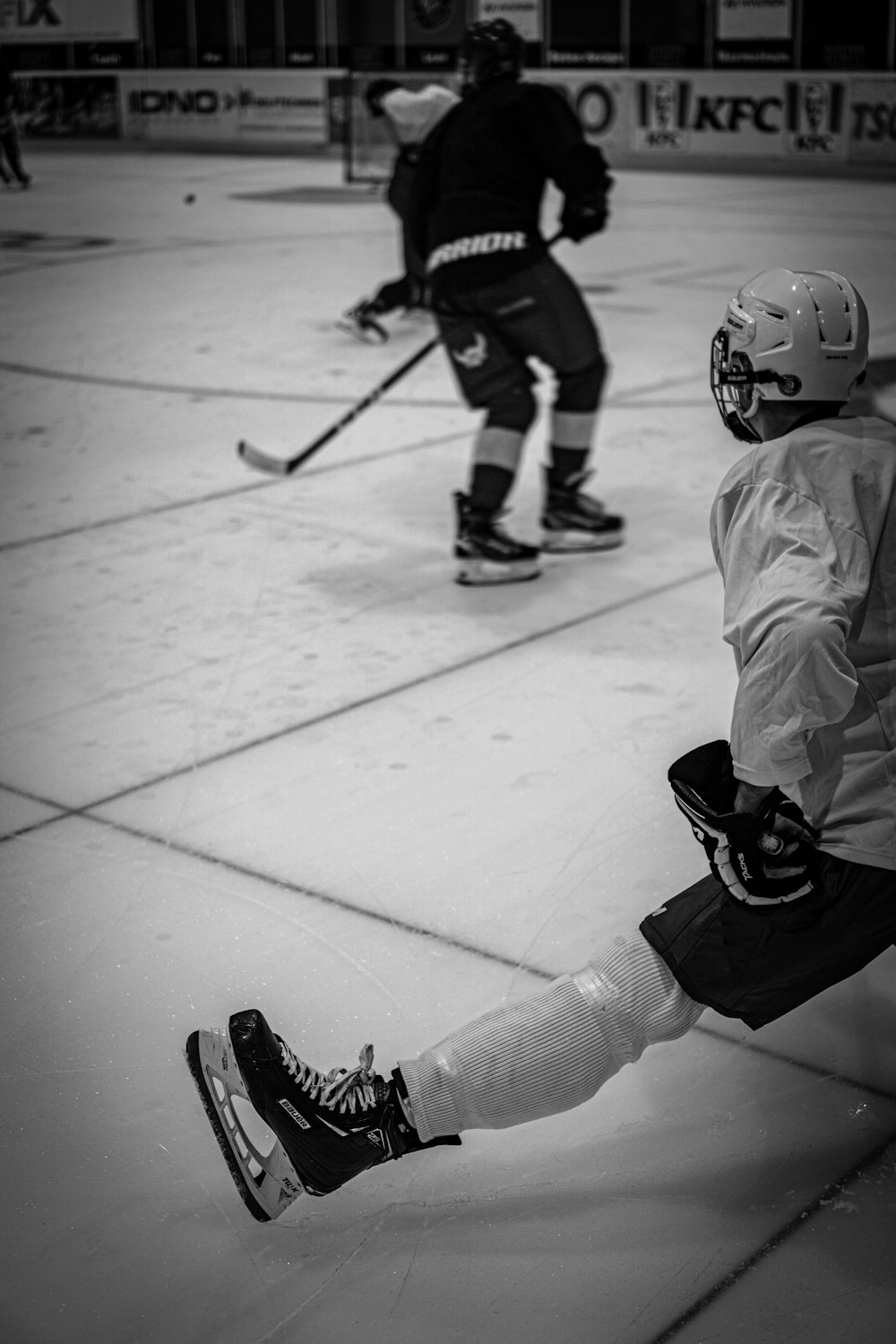 a couple of people playing a game of ice hockey