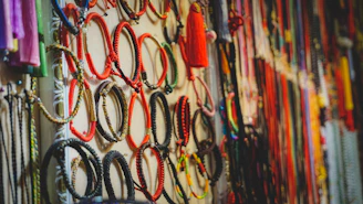 a bunch of bracelets are hanging on a wall