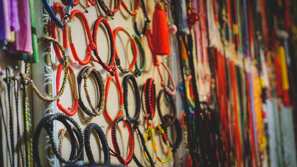 a bunch of bracelets are hanging on a wall