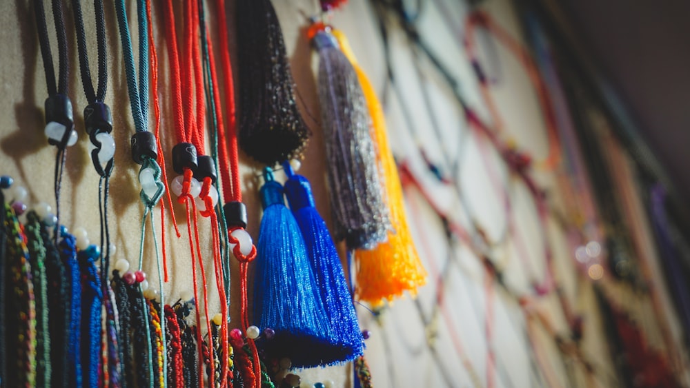 a bunch of beads hanging on a wall