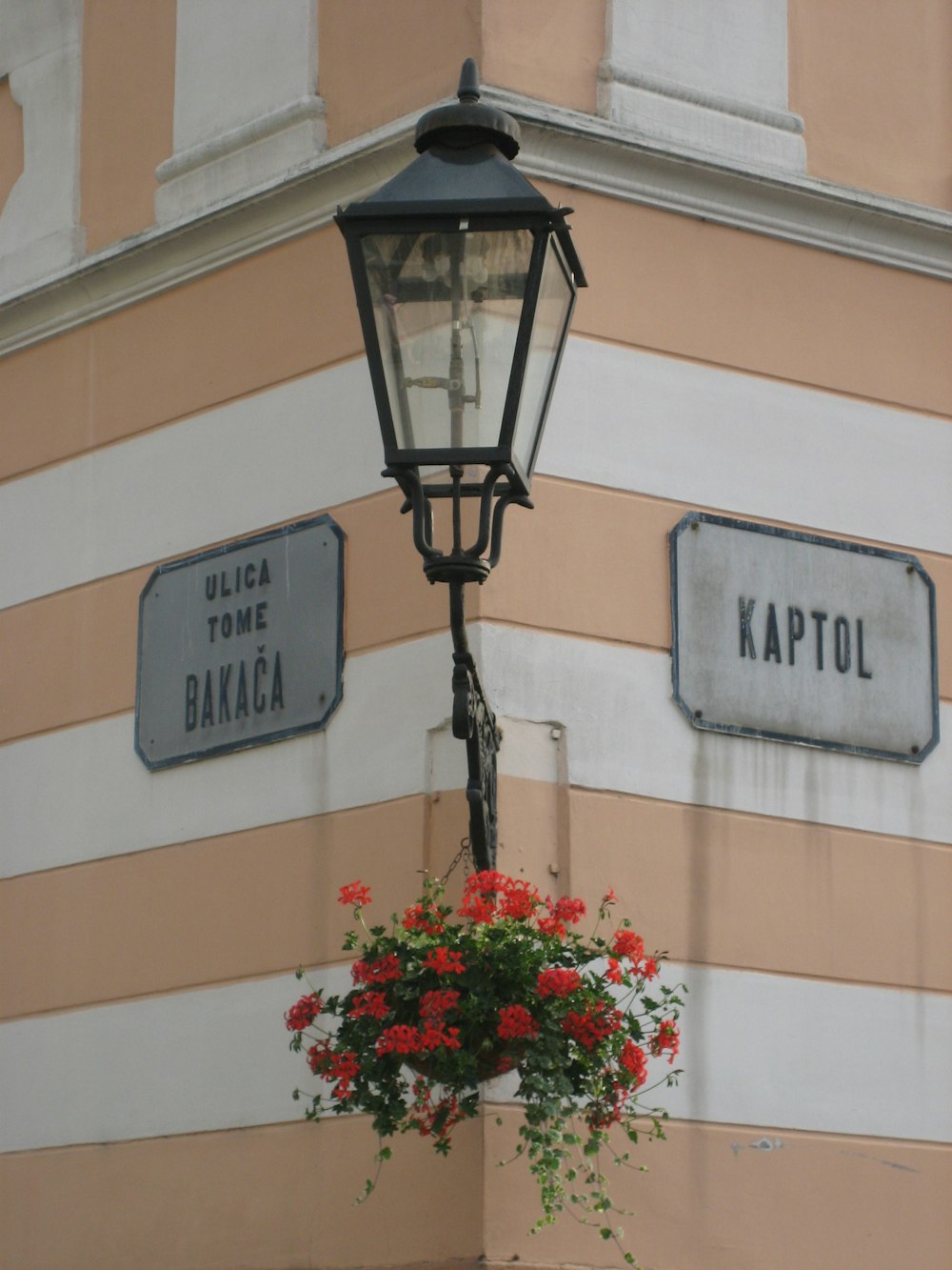 a lamp post with two street signs on it