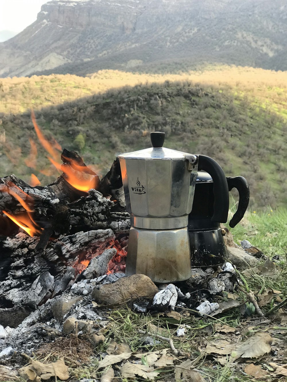 a stove top sitting on top of a pile of wood