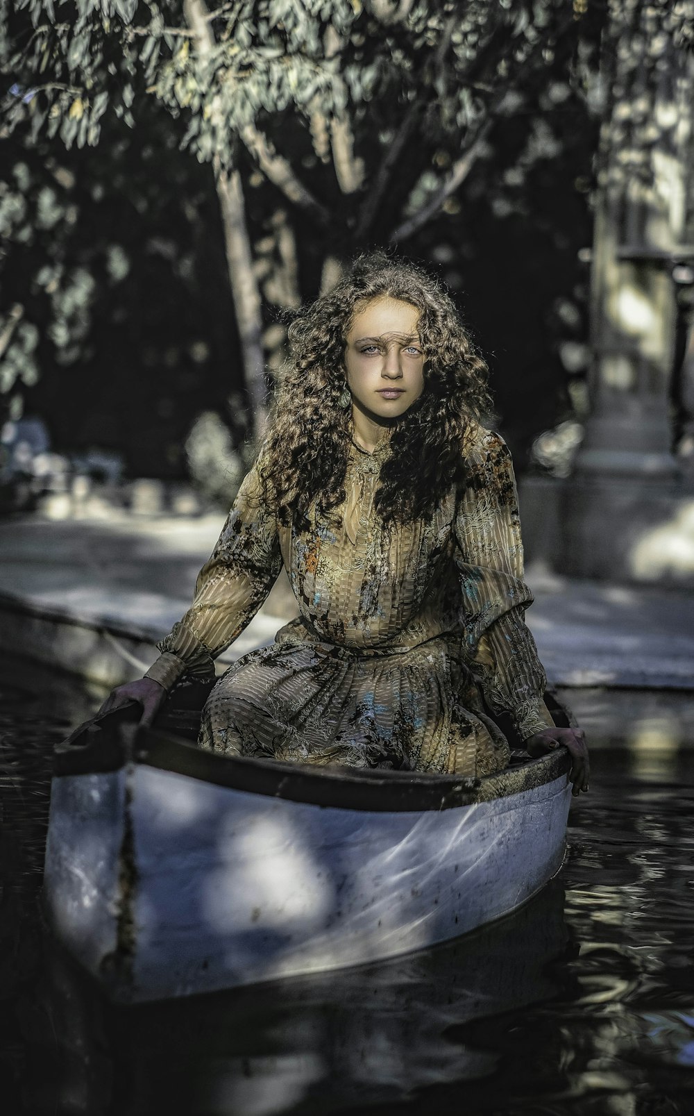 a woman is sitting in a boat on the water