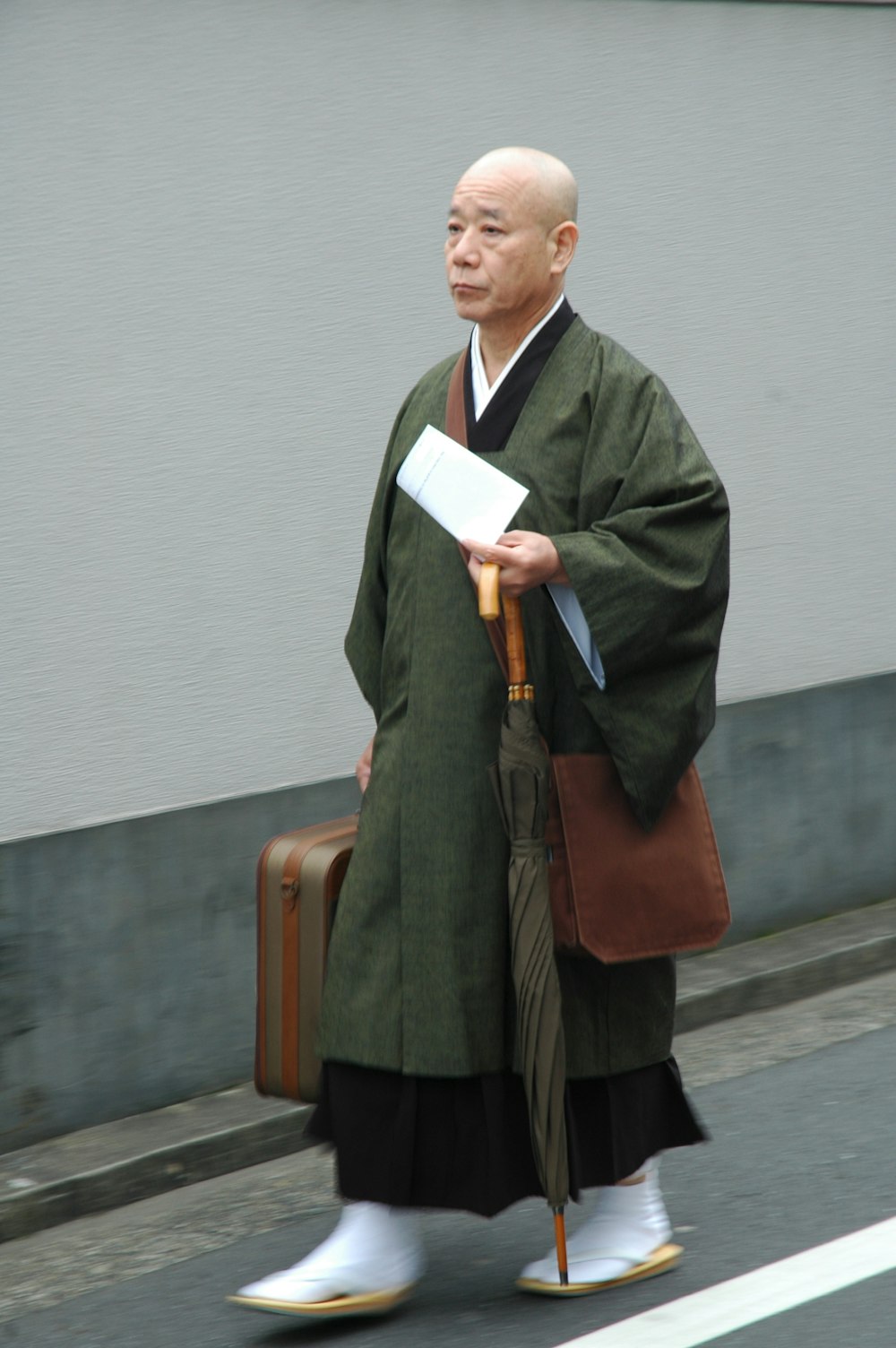 a man walking down a street holding a briefcase