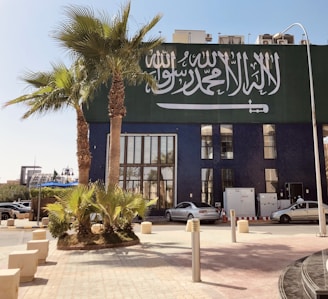 a building with a palm tree in front of it