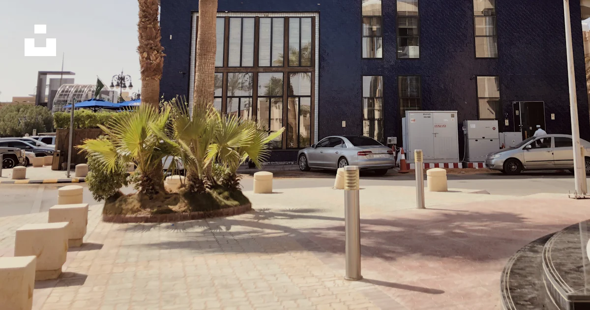 Palm Tree Rent Riyadh A building with a palm tree in front of it photo – Free Riyadh Image on ...