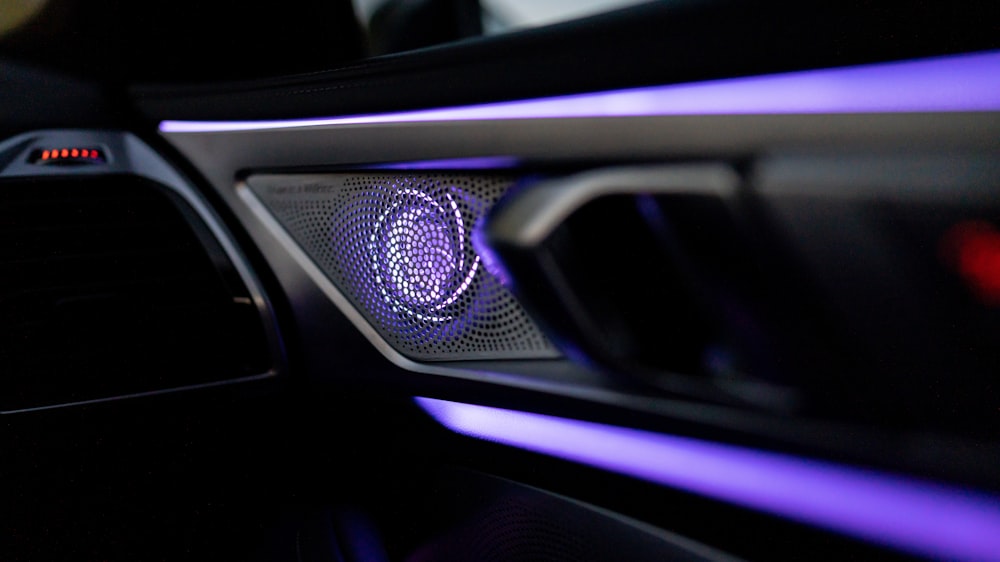 a close up of a car dashboard with a blue light