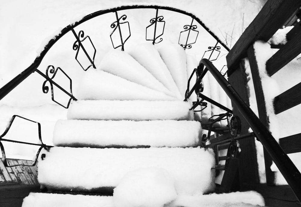 a black and white photo of a snow covered staircase