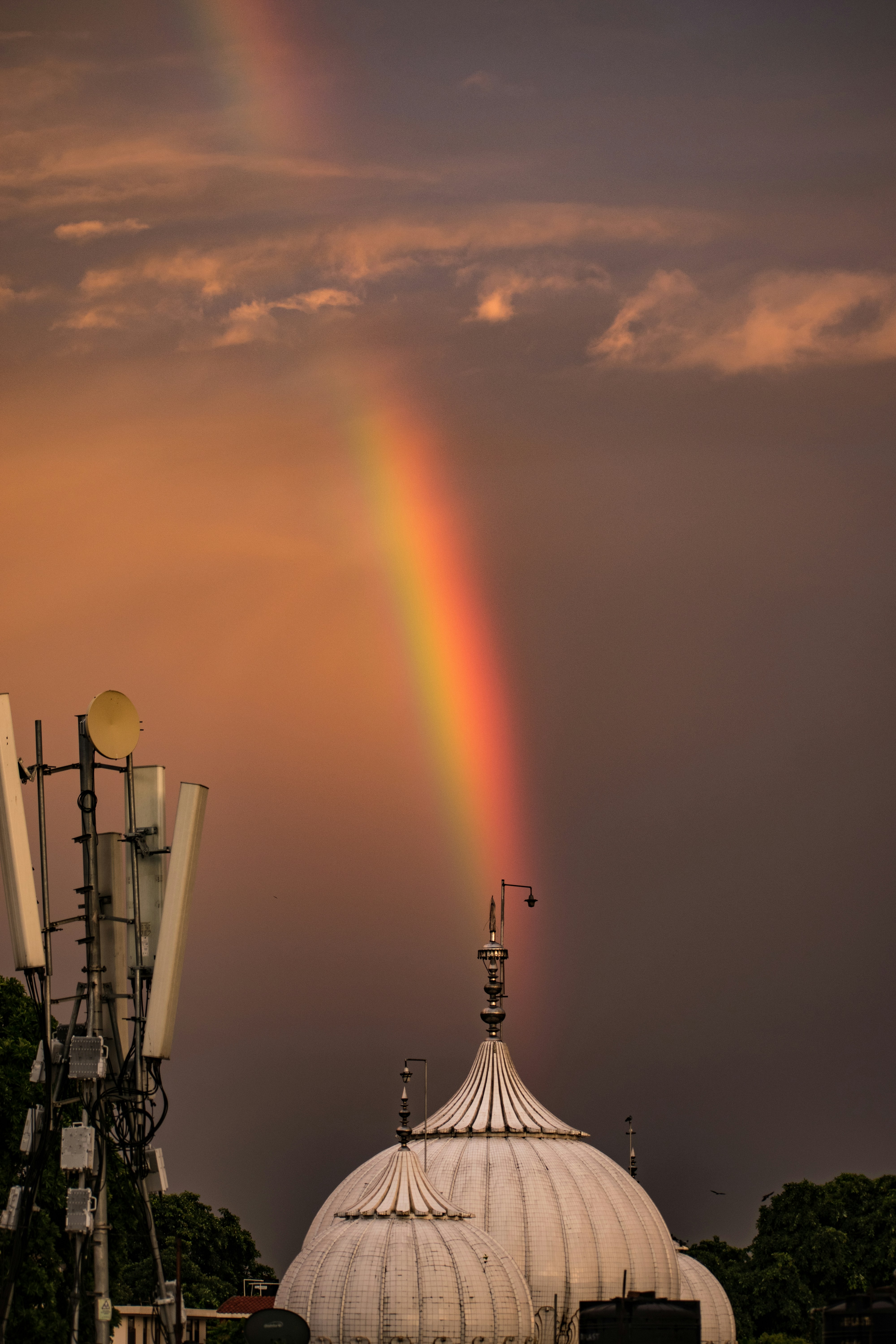 a rainbow in the sky over a building