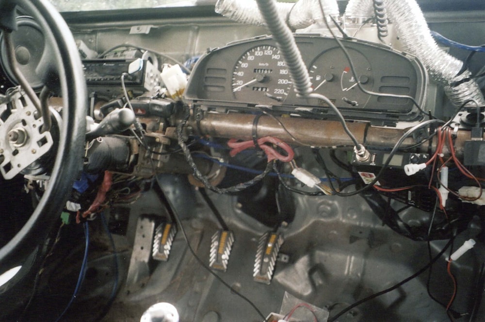 the dashboard of a car with many wires and wires