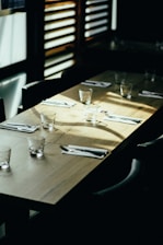 a wooden table with empty glasses on it