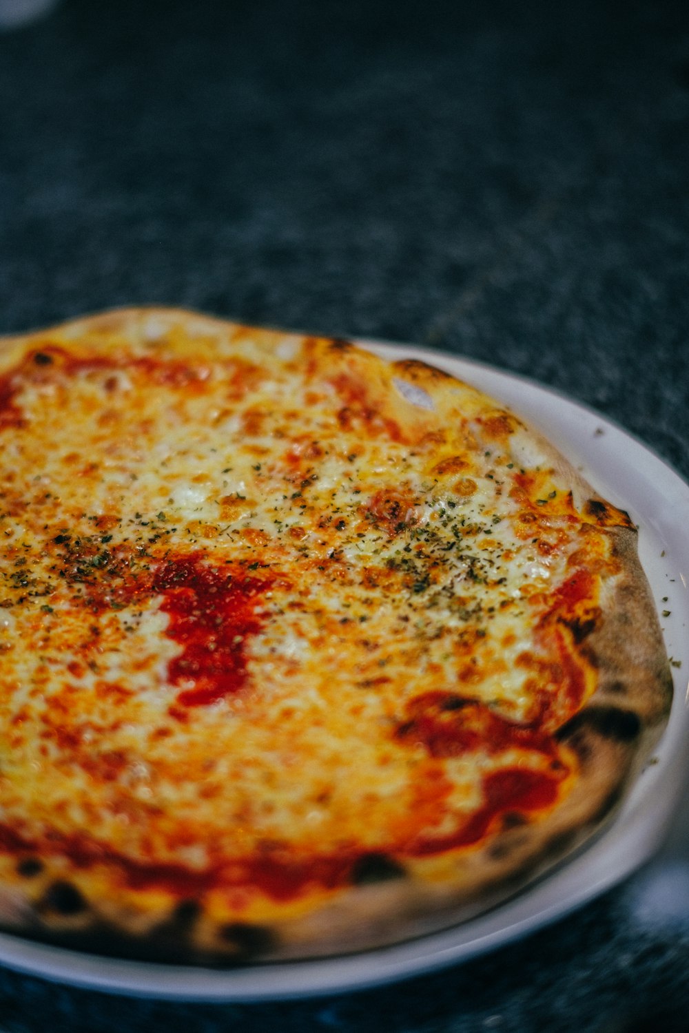 a pizza sitting on top of a white plate