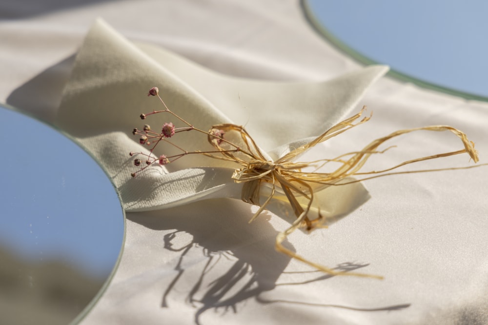 a close up of a cloth with a flower on it